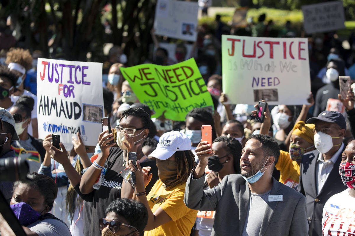 People react during a rally to protest the shooting of Ahmaud Arbery, an unarmed black man Frid ...