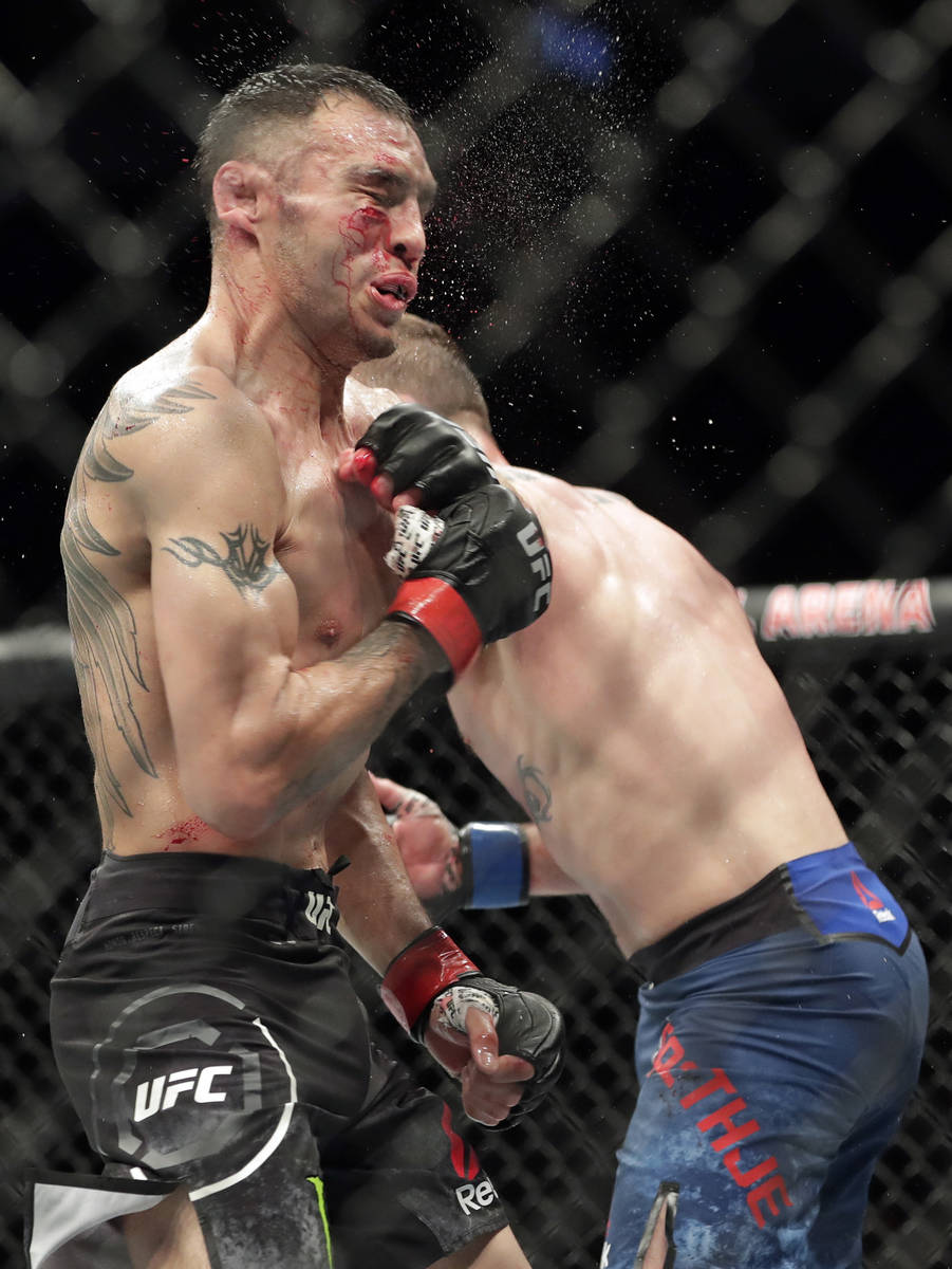 Tony Ferguson, left, takes a punch from Justin Gaethje during a UFC 249 mixed martial arts bout ...
