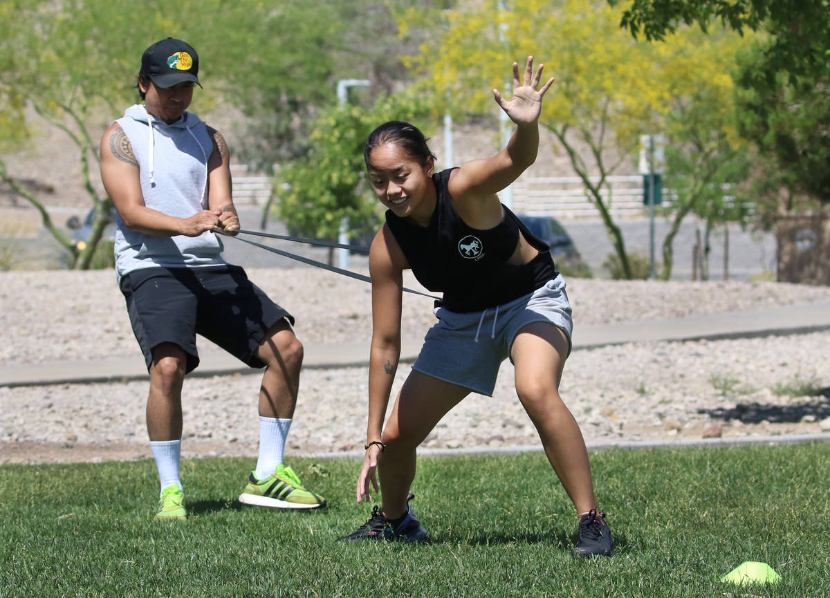 Liberty High School basketball player Raina Bitanga exercises with the help of her uncle Jonath ...