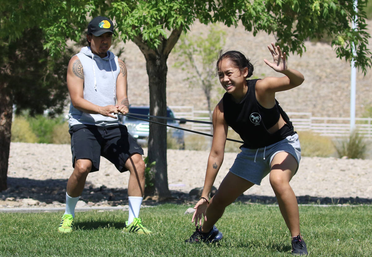 Liberty High School basketball player Raina Bitanga exercises with the help of her uncle Jonath ...