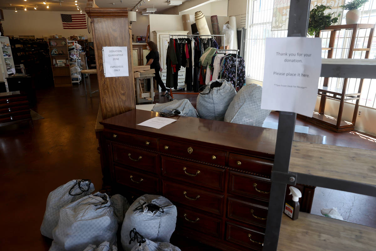 Dinosaurs & Roses Executive Director Michele Morgan, 60, loads donated items on the first d ...