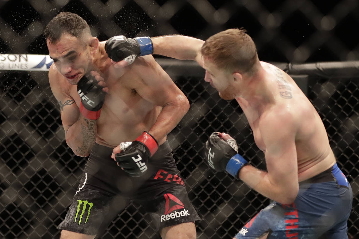 Justin Gaethje, right, punches Tony Ferguson during a UFC 249 mixed martial arts bout, Saturday ...