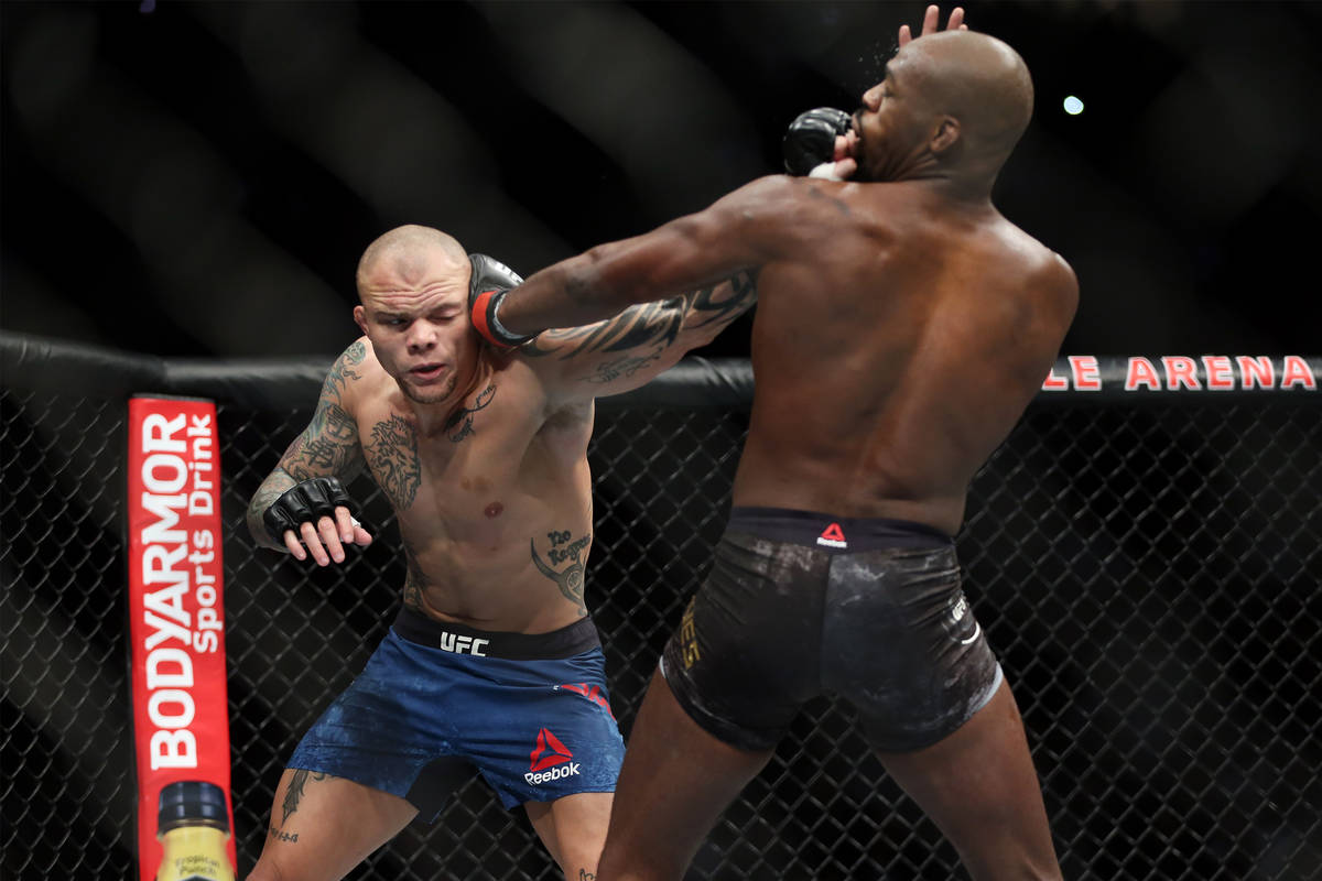 Anthony Smith, left, battles Jon Jones in the light heavyweight title bout during UFC 235 at T- ...