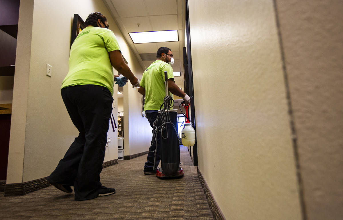 Mayola Lopez, left, and Anuar Flores, both of CitiClean Services, prepare to clean the lobby at ...