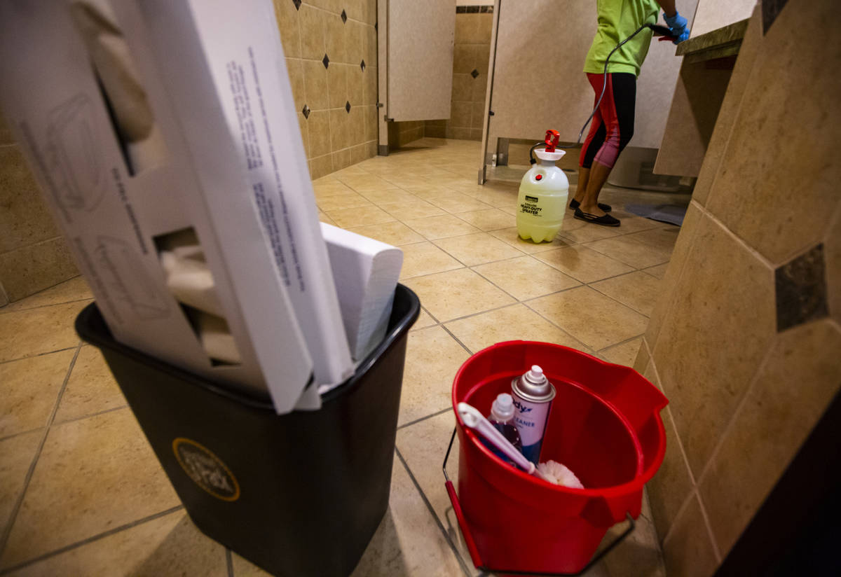 An employee of CitiClean Services disinfects a bathroom at the Gerrard Cox Larsen law firm in H ...