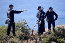 Police search a headland in Sydney, Tuesday, May 12, 2020, following an arrest in relation to t ...