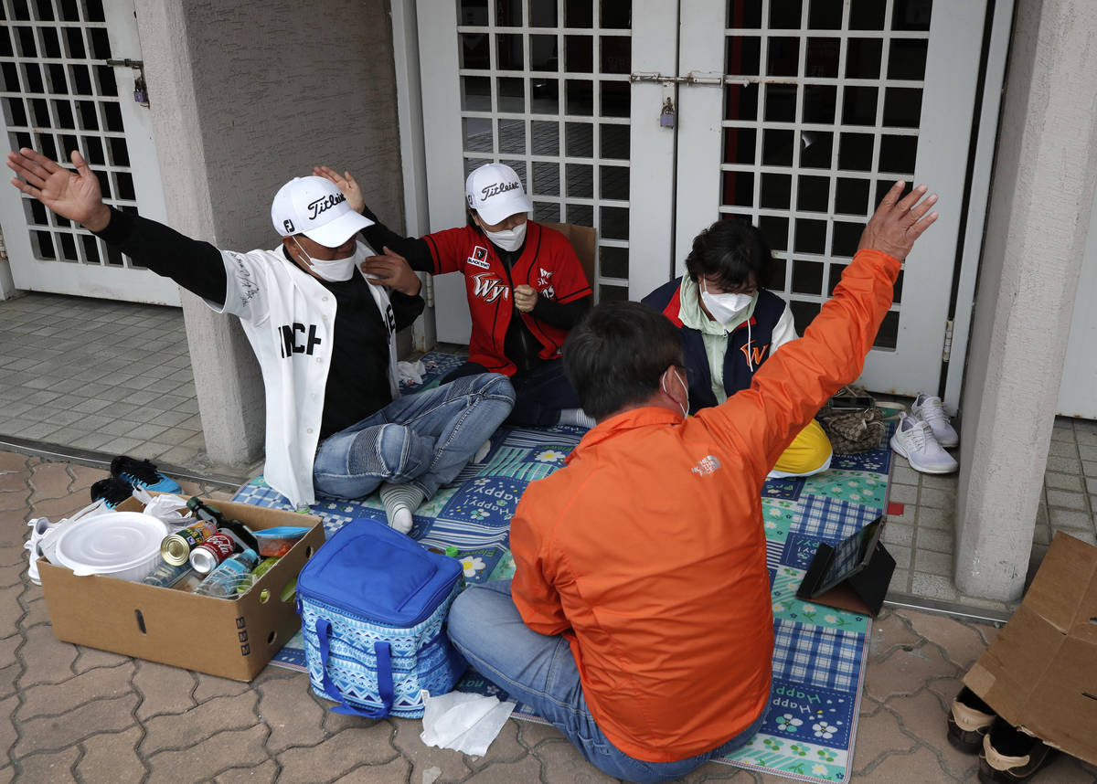 SK Wyverns baseball team fans wearing face masks watch the live baseball game outside the stadi ...