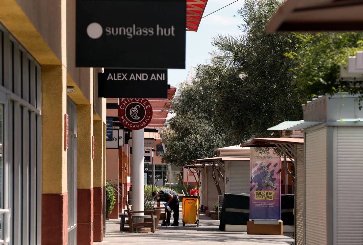 Ivan Leybe sanitizes customer areas within the Las Vegas North Premium Outlets as seen during a ...