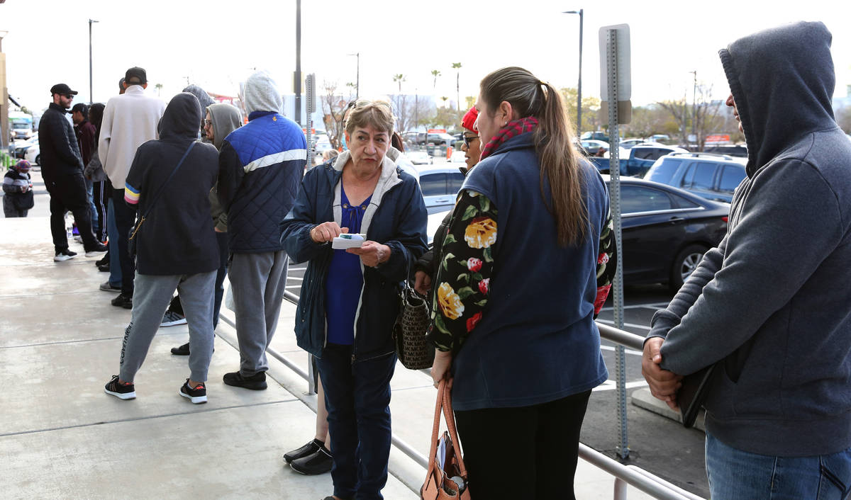 People wait in line at One-Stop Career Center on Tuesday, March 17, 2020, in Las Vegas. (Bizua ...