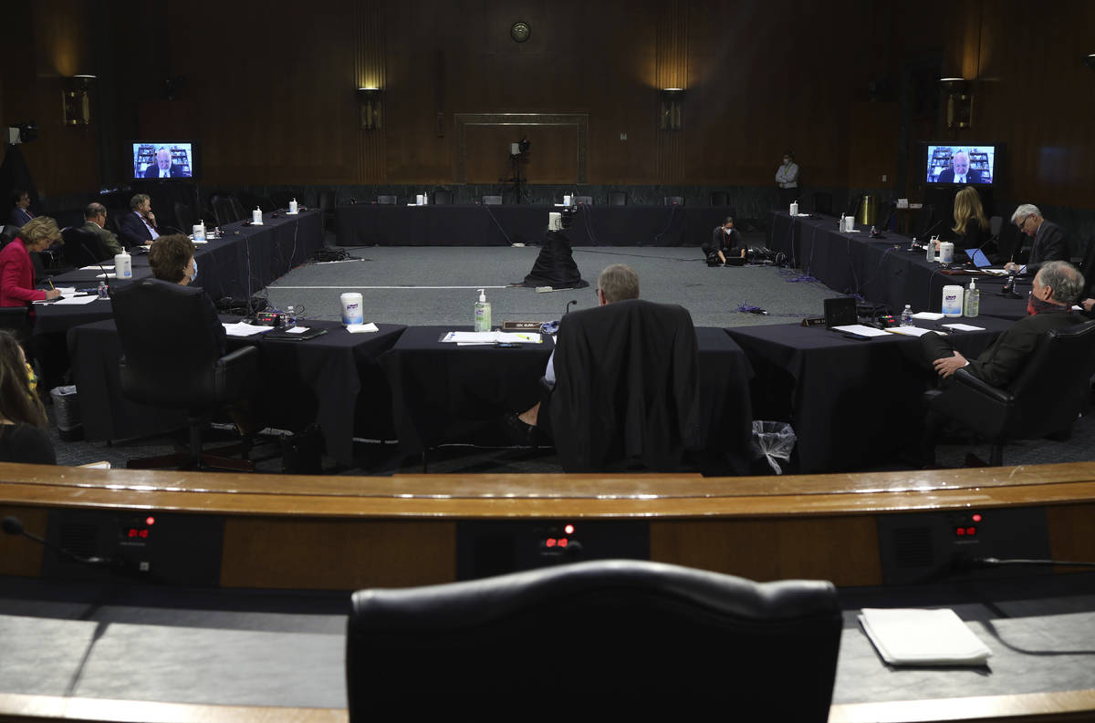 Dr. Robert Redfield, director of the Centers for Disease Control and Prevention, appears remote ...