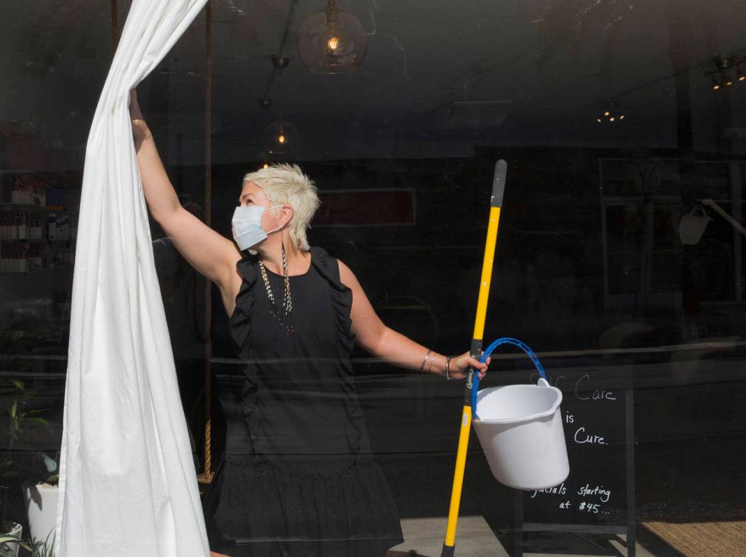 Megan Linney opens the curtain of her downtown Las Vegas skin care salon, The Layer Lounge, on ...