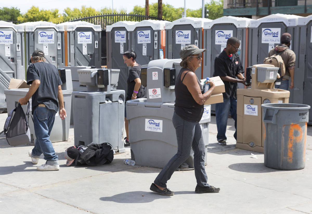 Clients wash their hands at hand washing stations at The Courtyard Homeless Resource Center on ...