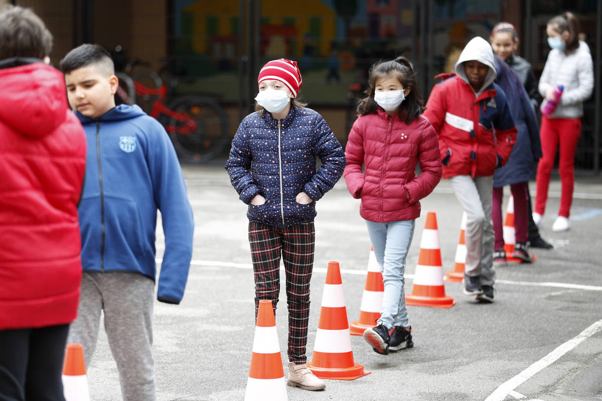 Schoolchildren wait in line to use the toilet in the schoolyard of the Sainte Aurelie primary s ...