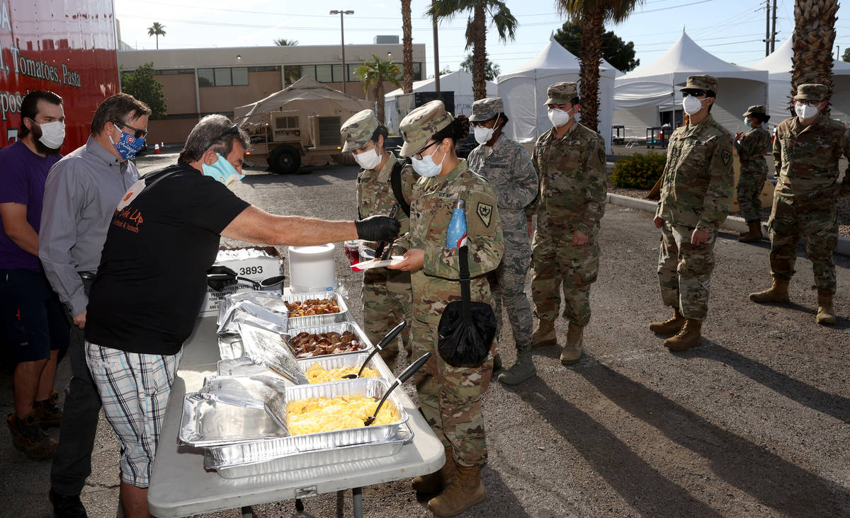 Nevada National Guard members who are helping with COVID-19 testing, including Spc. Kim Lo, get ...