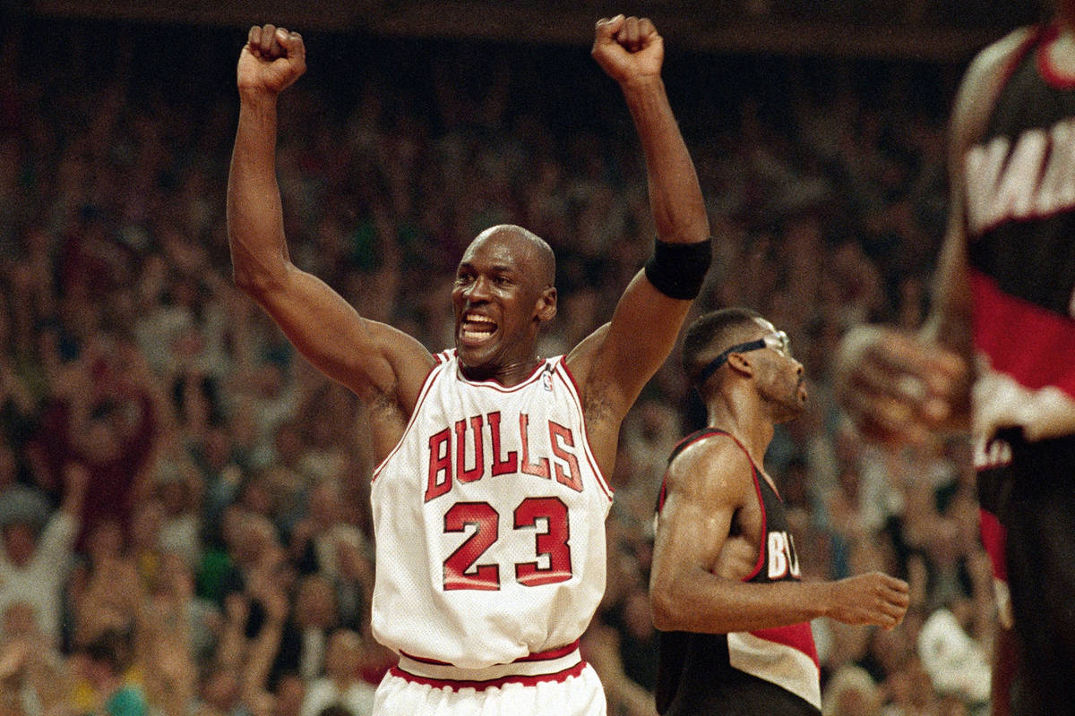 FILE - In this June 14, 1992, file photo, Michael Jordan celebrates the Bulls win over the Port ...