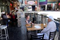 Sara Crane and James Hall, both of Henderson, dine outside at Hennessey's Tavern at the Fremont ...