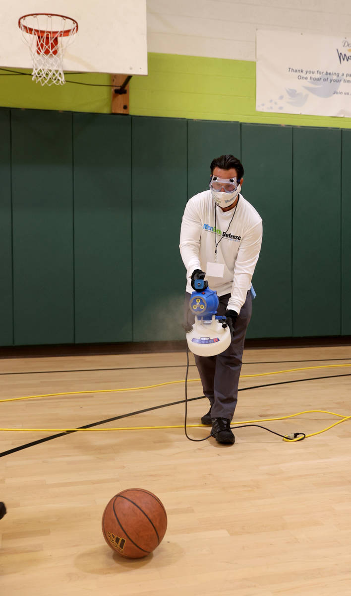 Technician Jan Grajewski of MicroGerm Defense Nevada uses an electrostatic sprayer at James Boy ...