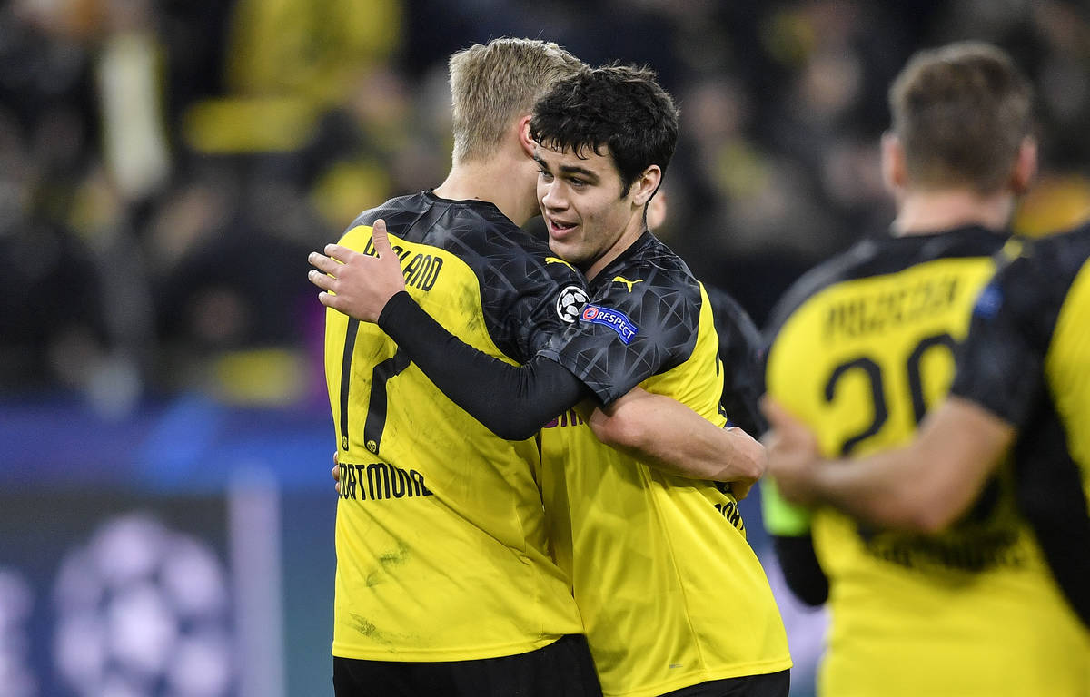 Dortmund's Giovanni Reyna, right, embraces Dortmund's Erling Braut Haaland after the Champions ...