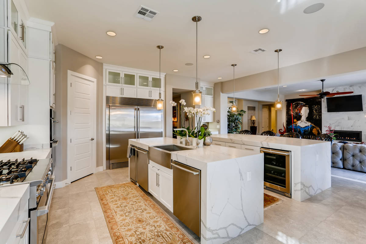 The kitchen has two large islands with plenty of room for seating and upgraded appliances. (Rea ...