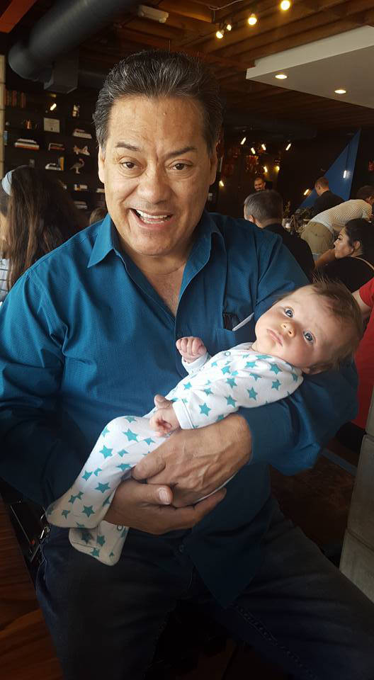 Luis A. Frias holds one of his six grandchildren. (Luisa Frias)