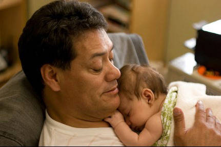 Luis A. Frias holds his first of six grandchildren. Frias, 65, died of the coronavirus on April ...