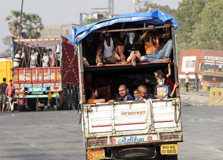 A truck carrying migrant workers leaves for Uttar Pradesh state, on the outskirts of Mumbai, In ...