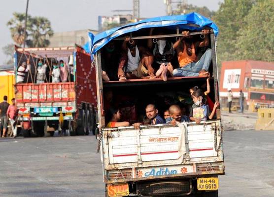 A truck carrying migrant workers leaves for Uttar Pradesh state, on the outskirts of Mumbai, In ...