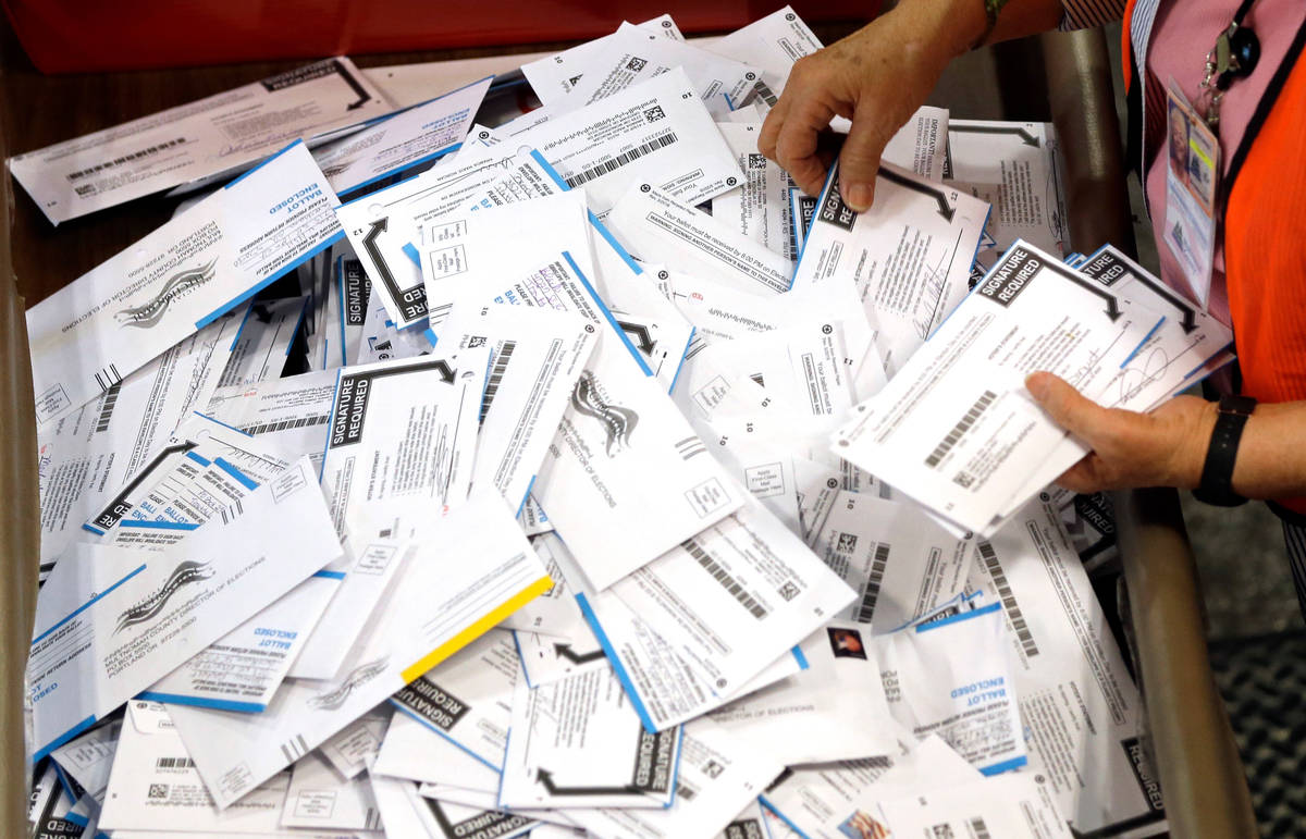 FILE - In this May 17, 2016, file photo, ballots are prepared for counting at Multnomah County ...