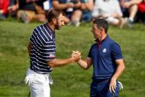In this Sept. 28, 2018, file photo, Dustin Johnson left, and Rory McIlroy shake hands on 16th g ...
