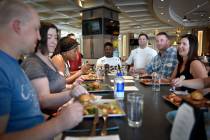 Herringbone restaurant chef Geno Bernardo, third from right, visits with customer during a Lip ...