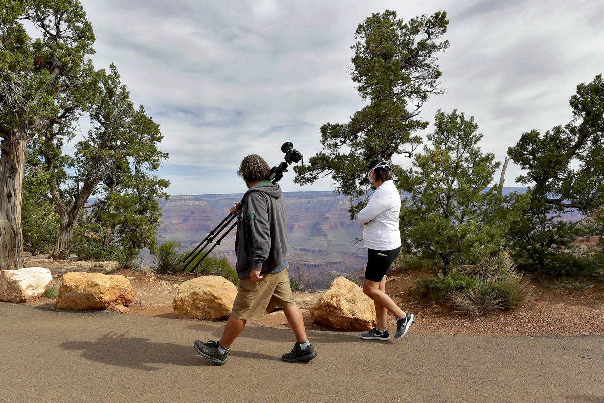 Visitors gather at the Grand Canyon Friday, May 15, 2020, in Grand Canyon, Ariz. Tourists are o ...