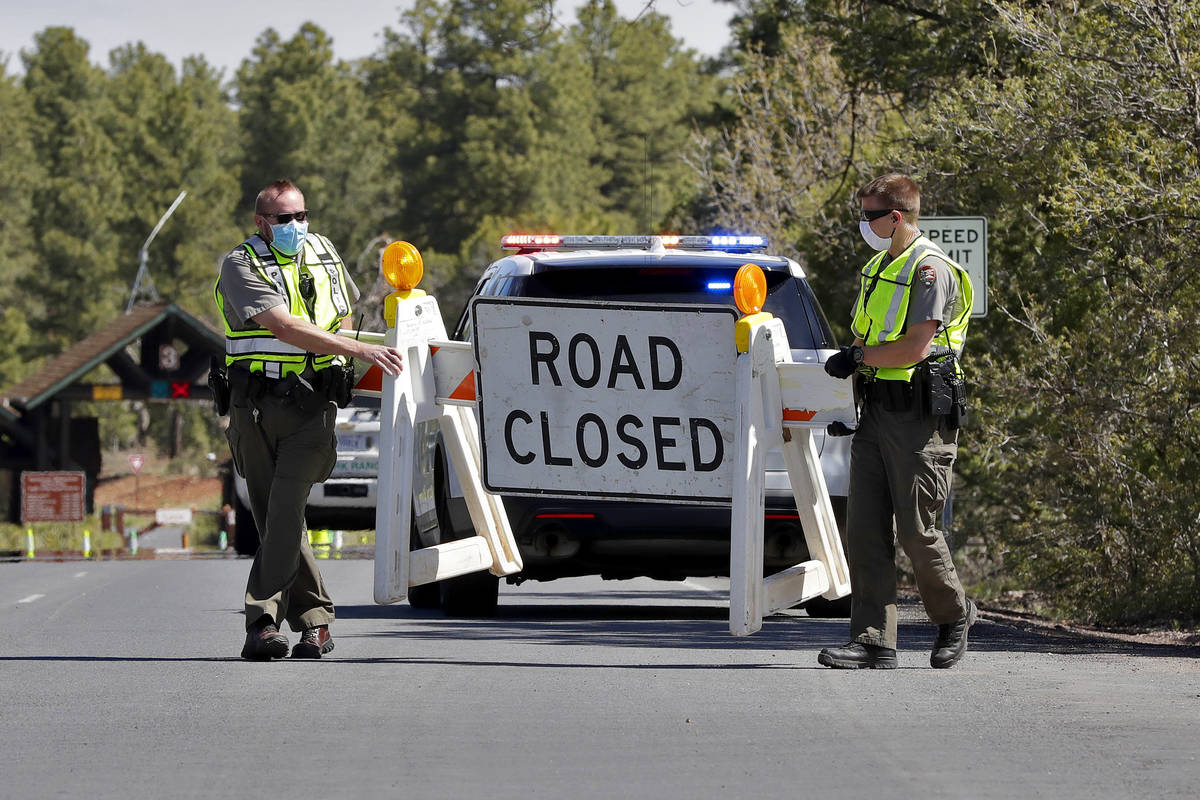 U.S. Park Rangers close the entrance to the Grand Canyon for the day Friday, May 15, 2020, in G ...