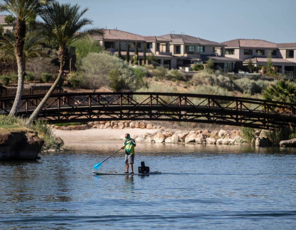 A paddle boarder passes under a bridge at Lake Las Vegas on Friday, May 15, 2020, in Henderson. ...
