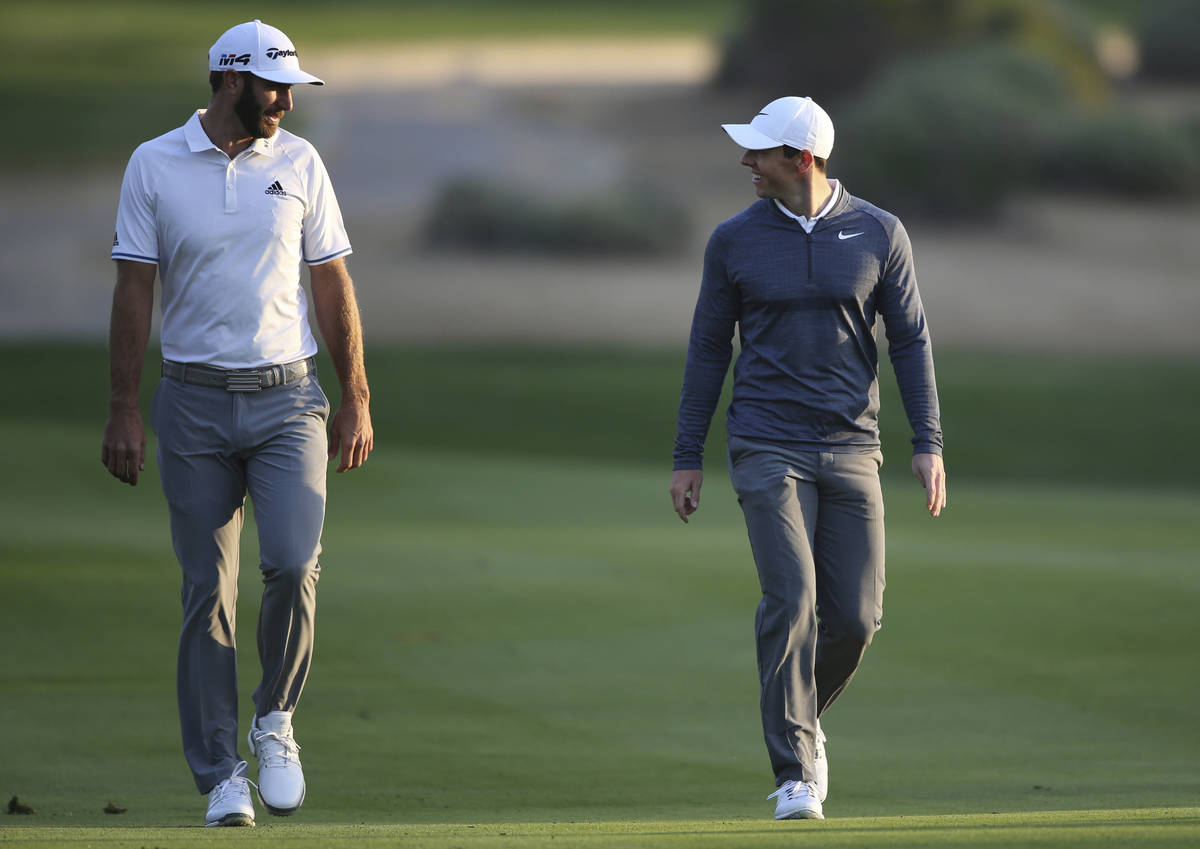 FILE - In this Jan. 18, 2018, file photo, Dustin Johnson of the United States, left, and Rory M ...