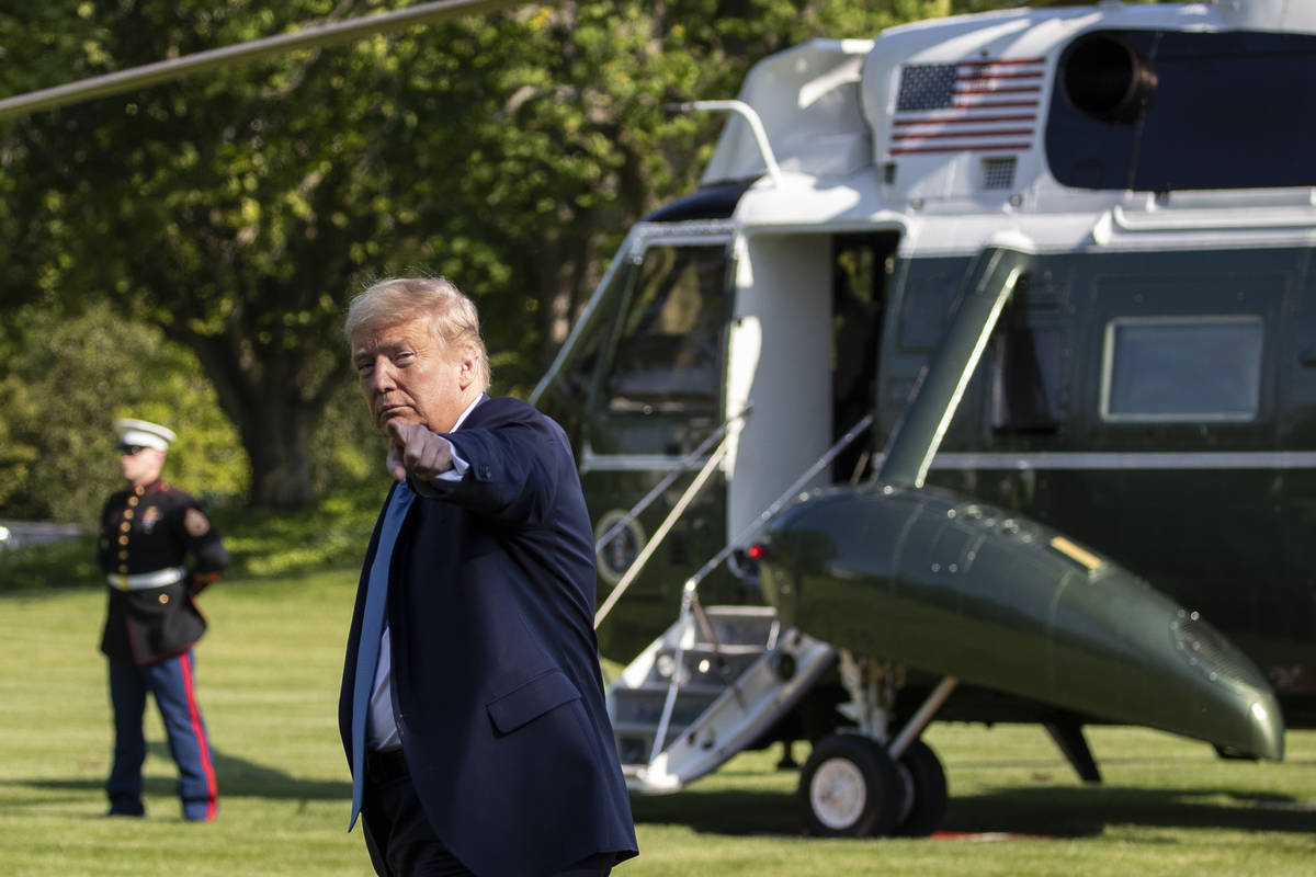 President Donald Trump points as the walks on the South Lawn as he departs the White House on M ...