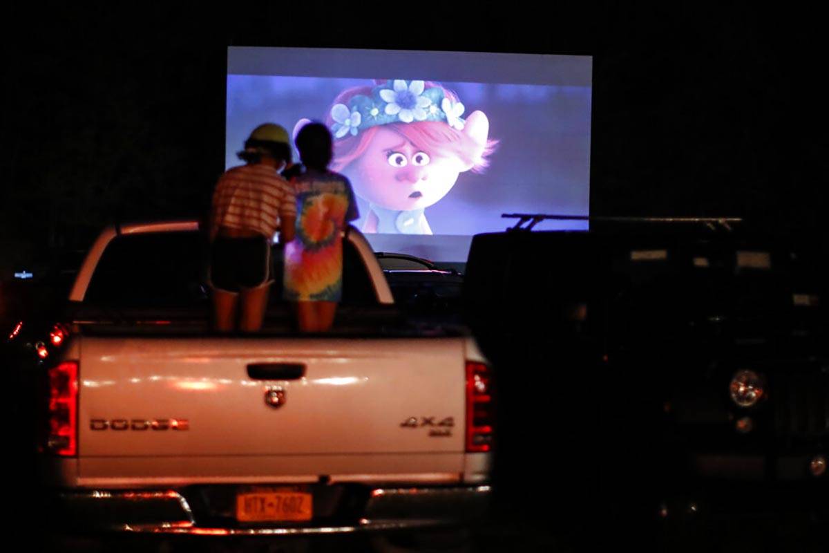 Guests watch a showing of "Trolls World Tour" at the Four Brothers Drive In Theatre, ...