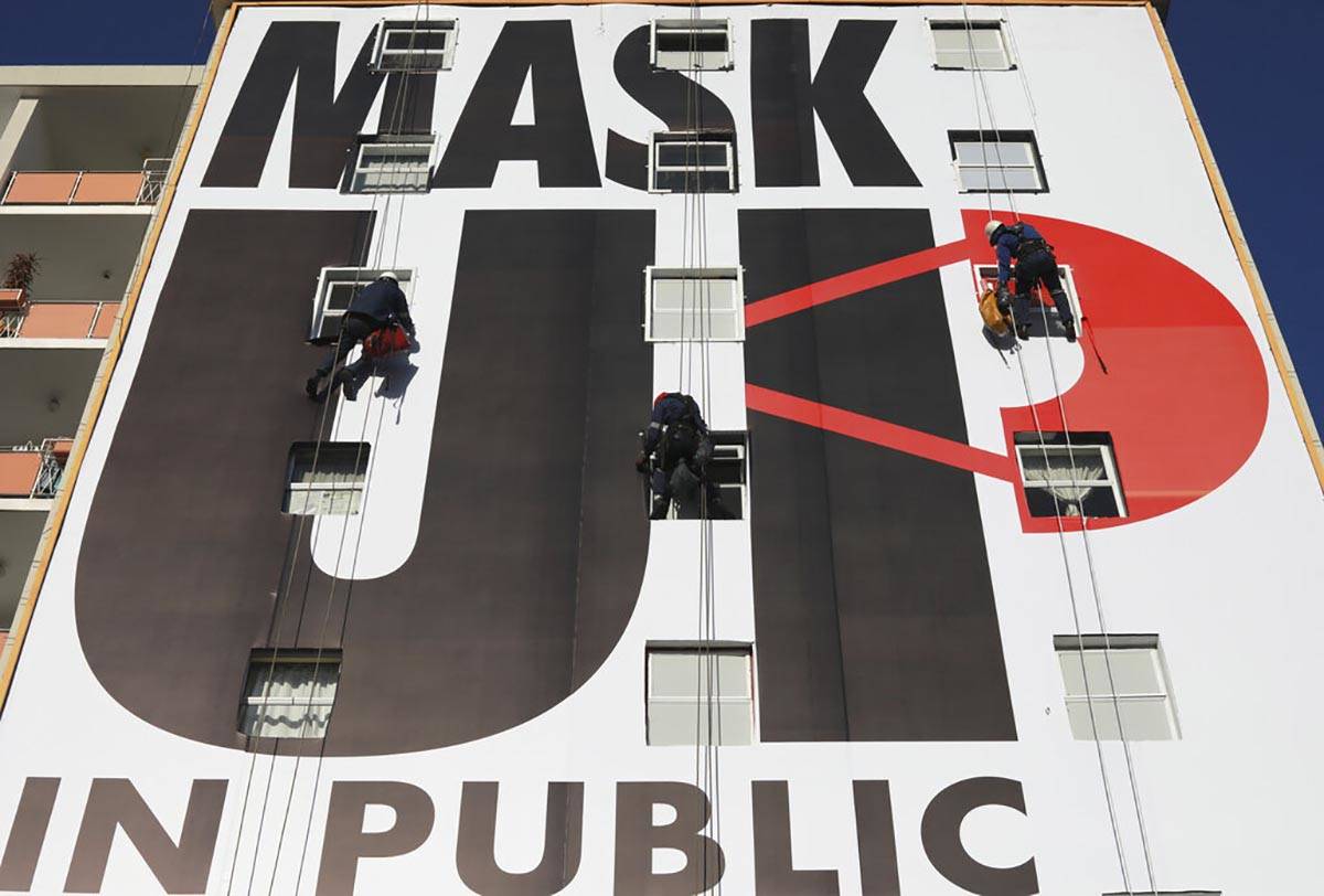 A billboard is installed on an apartment building encouraging people to wear face masks in Cape ...