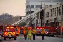 Los Angeles Fire Department firefighters work the scene of a structure fire that injured multip ...
