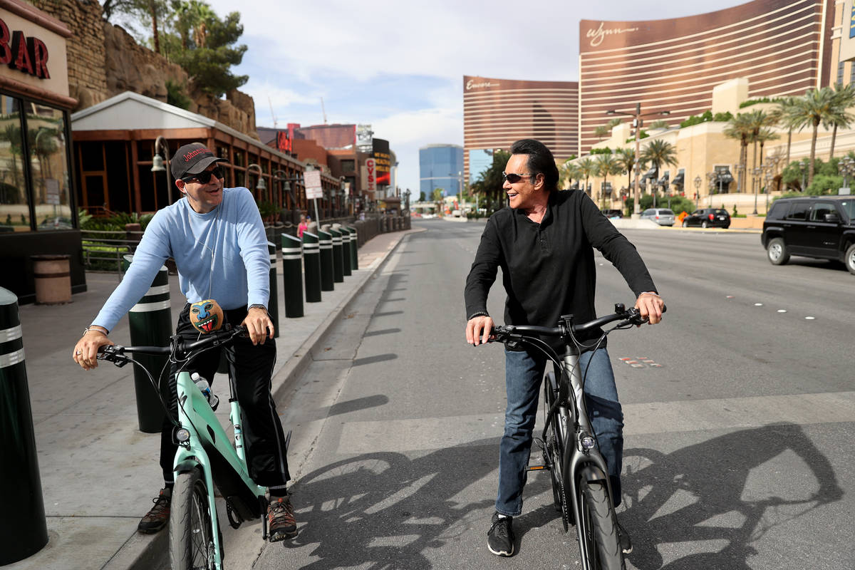 Mr. Las Vegas Wayne Newton, right, rides a bicycle on the Strip in Las Vegas with Las Vegas Rev ...