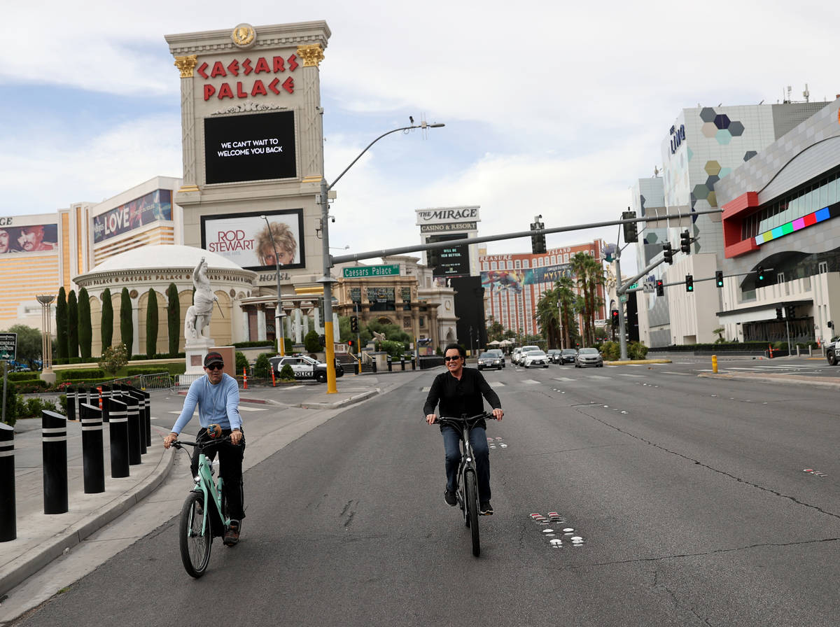 Mr. Las Vegas Wayne Newton, right, rides a bicycle on the Strip in Las Vegas with Las Vegas Rev ...