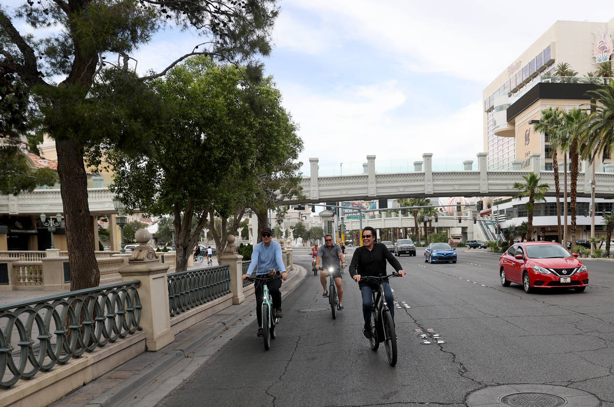 Mr. Las Vegas Wayne Newton, center, rides a bicycle on the Strip in Las Vegas with Las Vegas Re ...