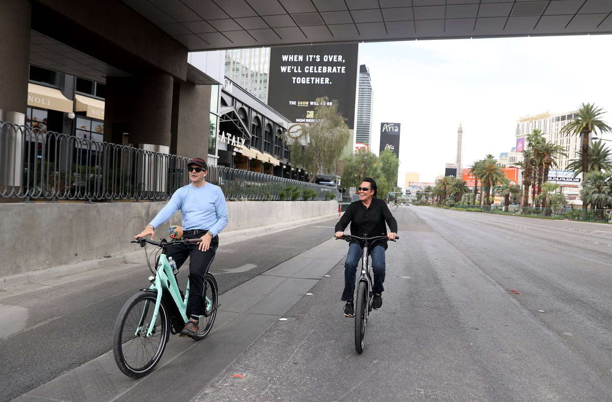 Mr. Las Vegas Wayne Newton, right, rides a bicycle on the Strip in Las Vegas with Las Vegas Rev ...