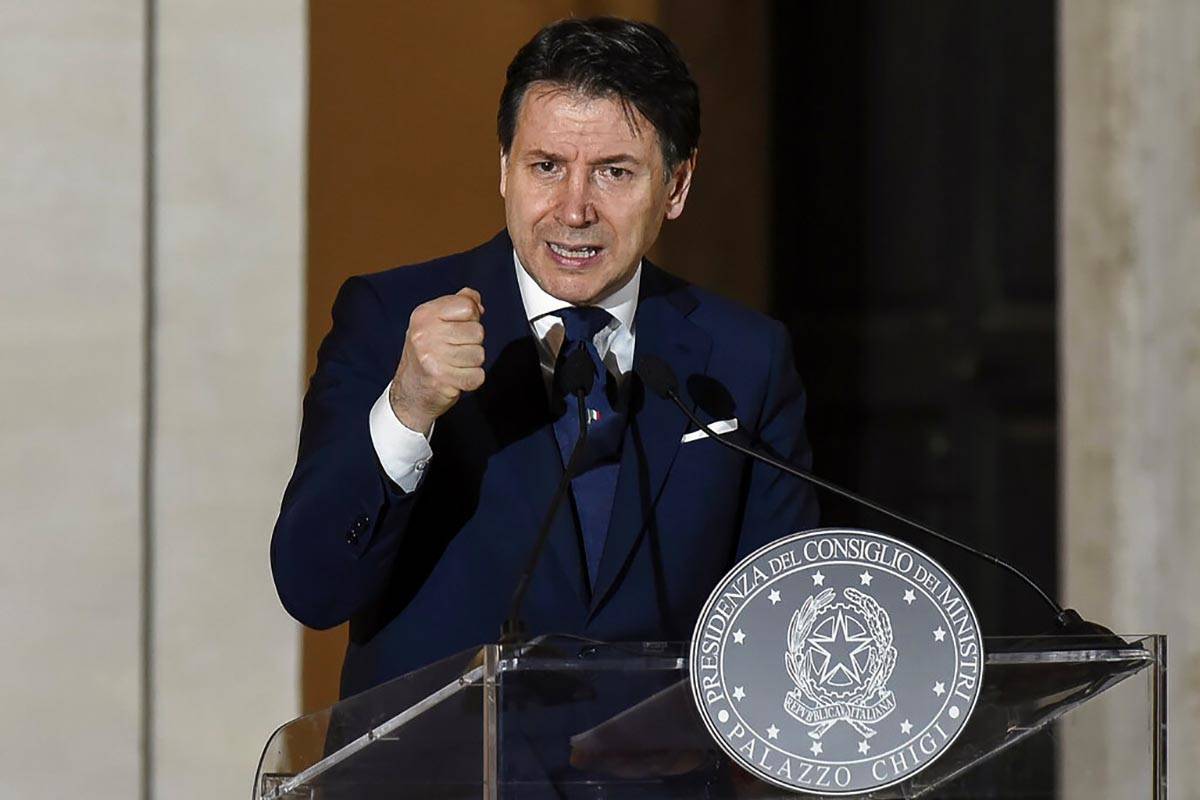 In this photo taken Saturday night, May 16, 2020, Italian Premier Giuseppe Conte holds a press ...