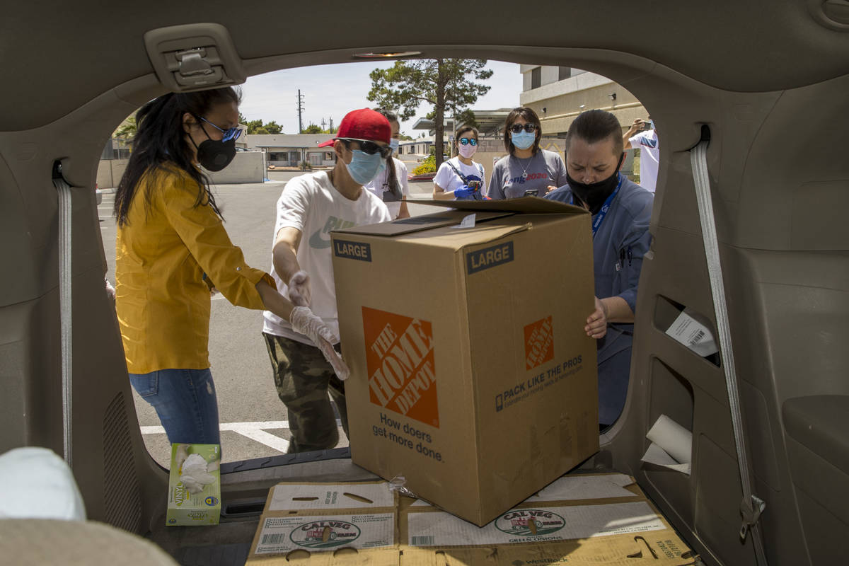 China Mama Restaurant's Ching Margos, left, and Bing Chou grab another large box of meals with ...