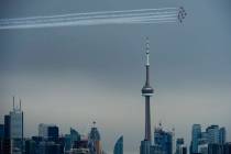 FILE-The Canadian Snowbirds circle the CN Tower as part of Operation Inspiration during the COV ...