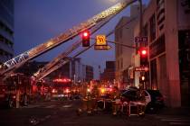 Los Angeles Fire Department firefighters work the scene of a structure fire that injured multip ...