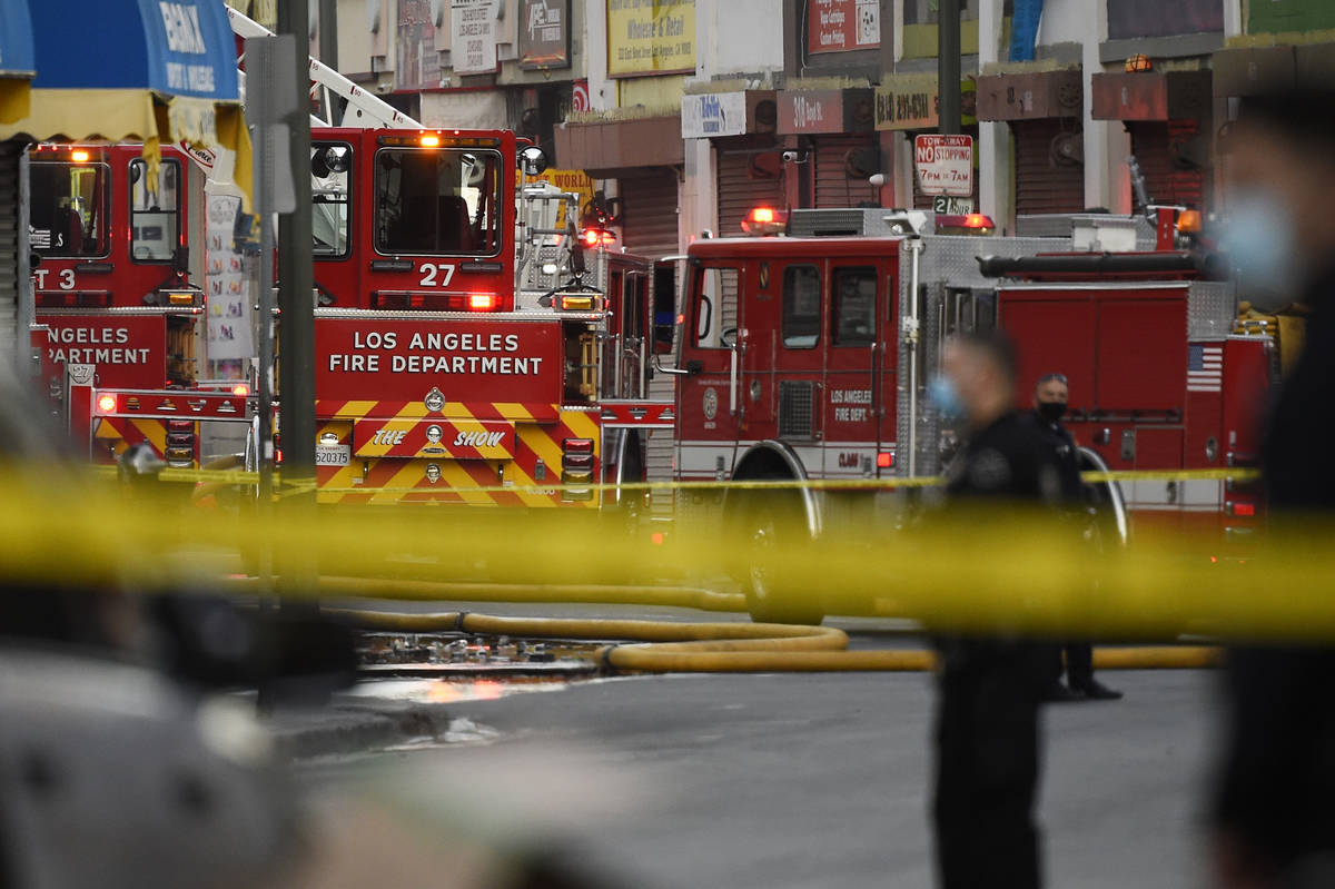 Los Angeles Police Department officers work the scene of a structure fire that injured multiple ...