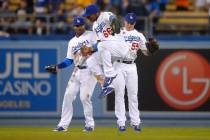 Dodgers outfielders Yasiel Puig (66), Skip Schumaker (55) and Carl Crawford celebrate Tuesday a ...