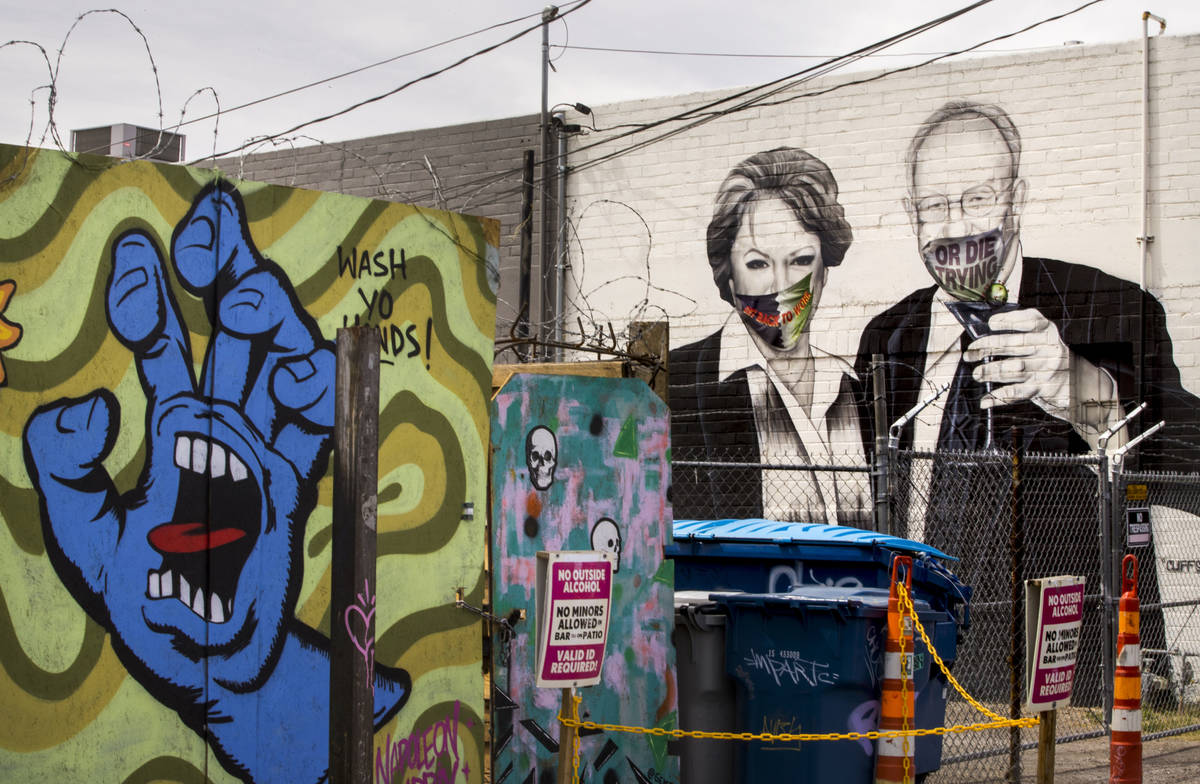 Mayor Carolyn Goodman and husband Oscar are portrayed in a mural now wearing face masks along a ...