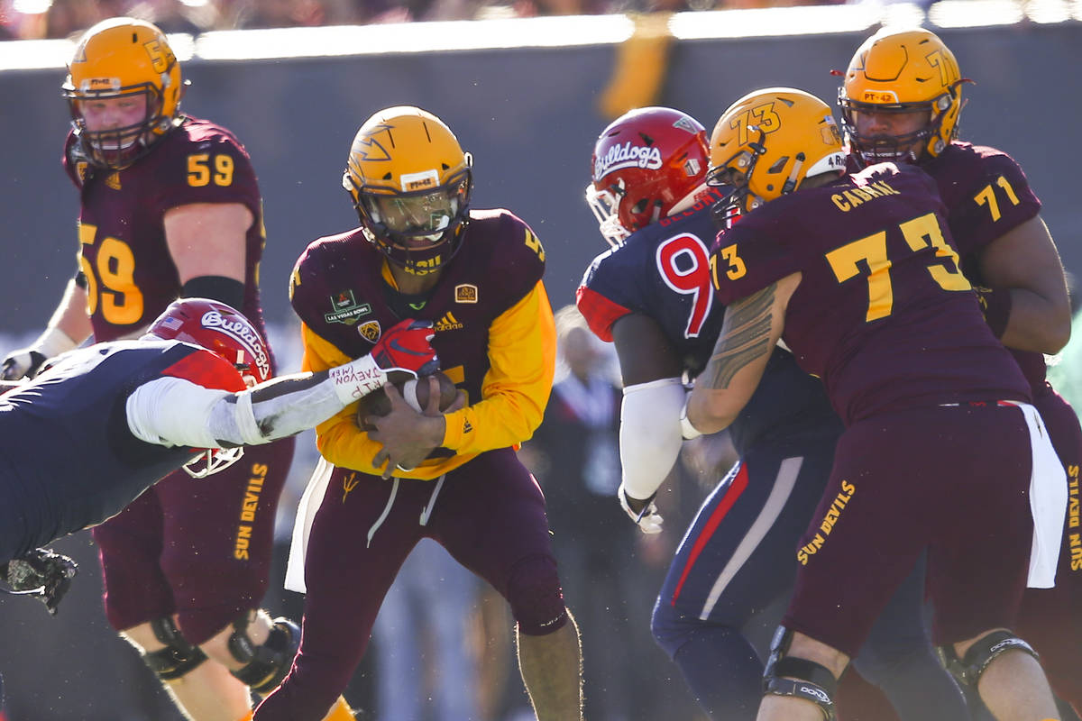 Fresno State linebacker Jeff Allison, left, tries to stop Arizona State quarterback Manny Wilki ...